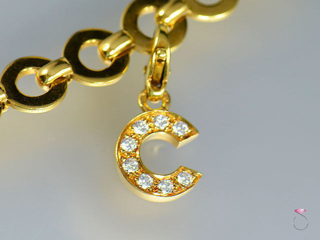 18k yellow gold Chanel “C” logo diamond charm with 8 round diamonds